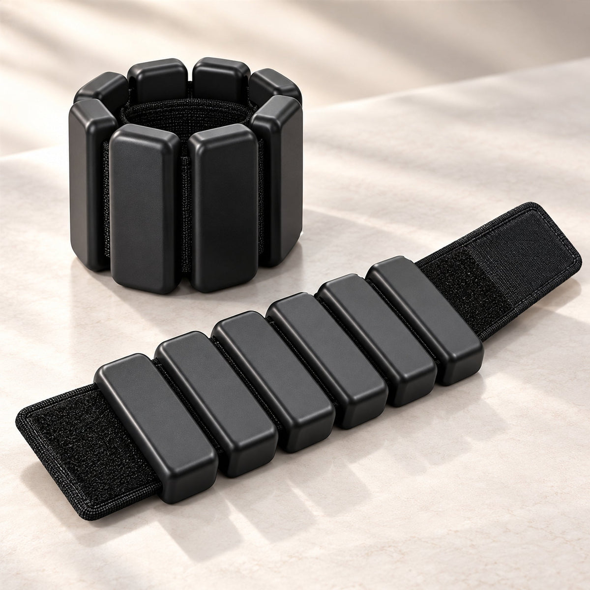 Black adjustable wrist or ankle weights with segmented design, set of two