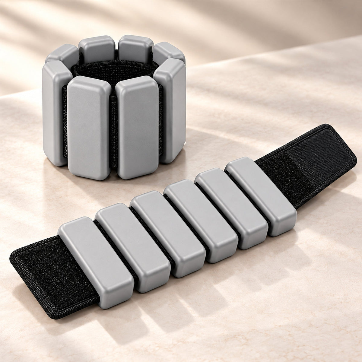 Grey adjustable wrist or ankle weights with segmented design, set of two