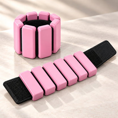 Pink adjustable wrist or ankle weights with segmented design, set of two